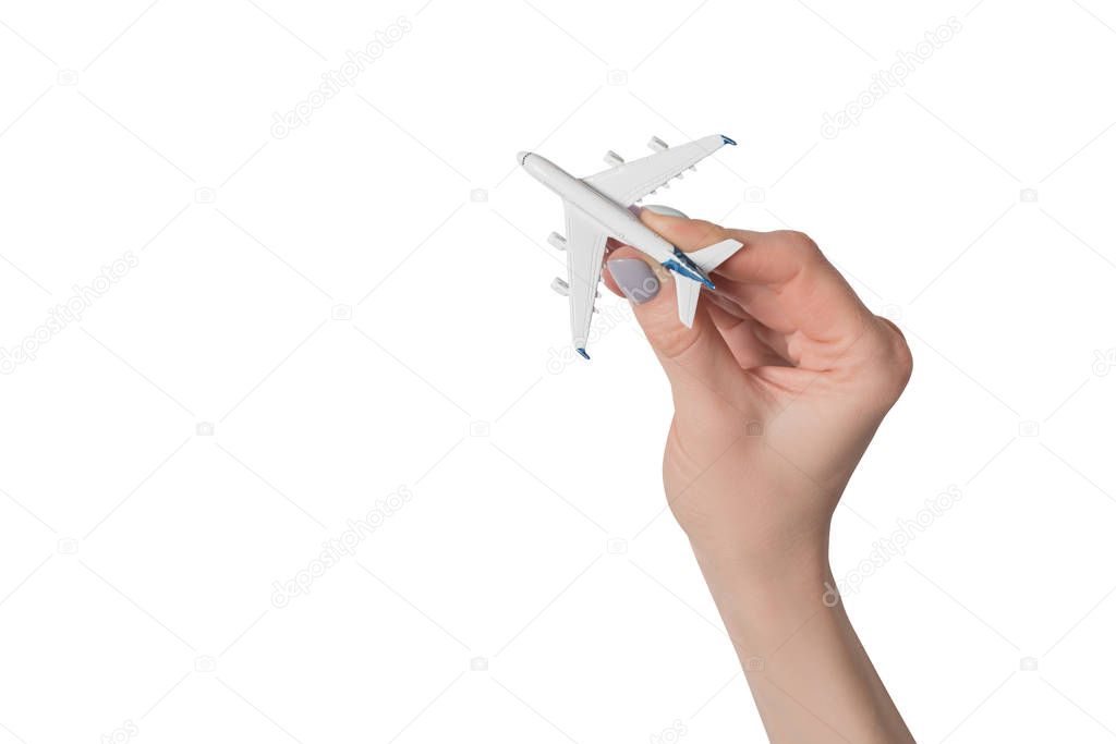 Passenger plane in female hand isolate on white background. Concept of safe flights