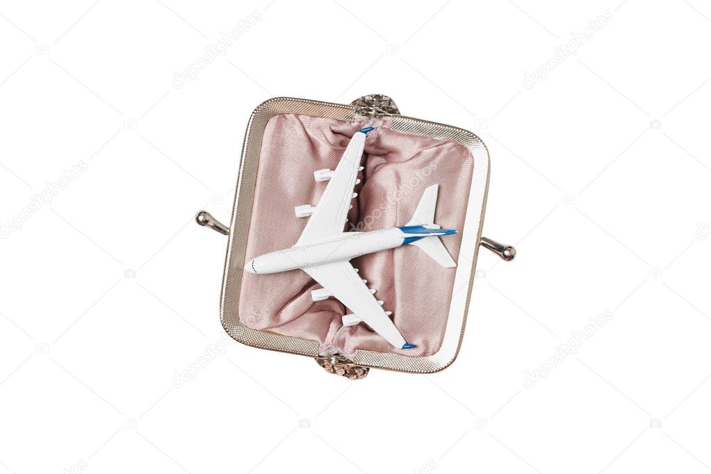 Passenger plane in open wallet on a light background. Low-cost concept