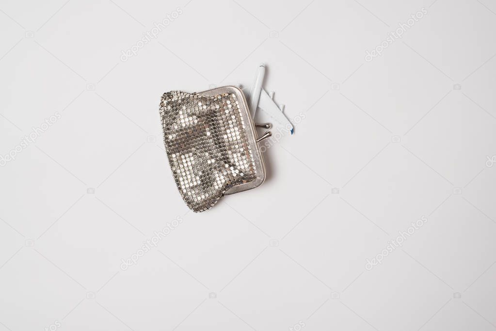 Passenger plane in wallet on a light background. Low-cost concept