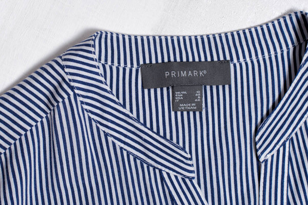 KHARKOV, UKRAINE - MARCH 04, 2019: Label PRIMARK on striped blouse. Fashion concept. Close up