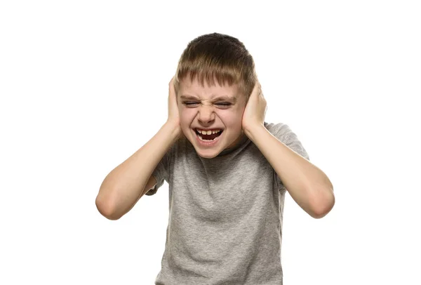 Boy closed his ears with his hands and shouts furiously. Naughty schoolboy. Isolate — Stock Photo, Image