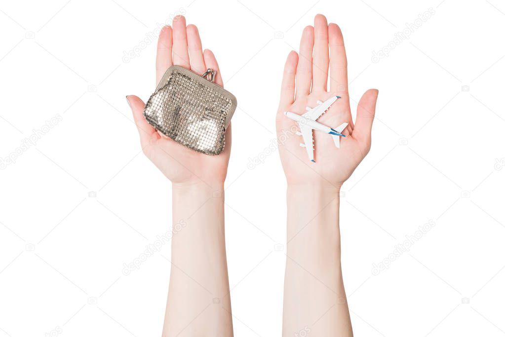 Passenger plane and wallet on female palms on a light background. Cheap flights