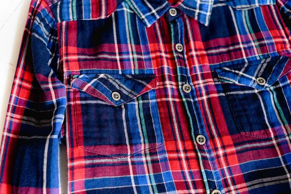 Concepto de ropa. Detalles de camisa a cuadros sobre fondo de madera. Vista superior. Detalles — Foto de Stock