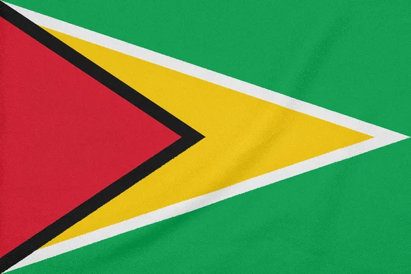 Bandera de Guyana sobre tela texturizada. Símbolo patriótico — Foto de Stock