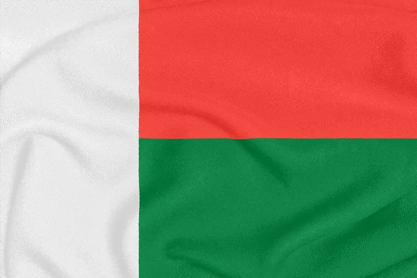 Vlag van Madagaskar op getextureerde stof. Patriottisch symbool — Stockfoto