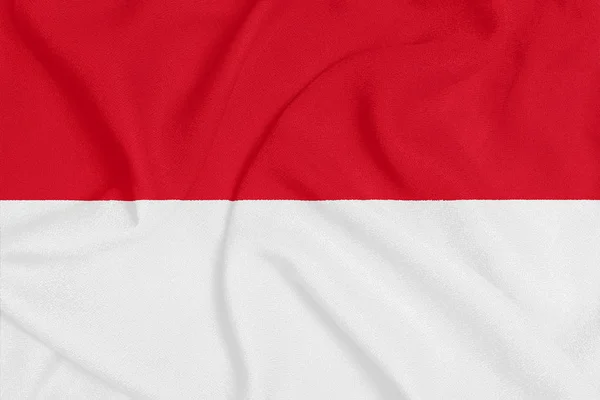 Flagge von Monaco auf texturiertem Stoff. Patriotisches Symbol — Stockfoto