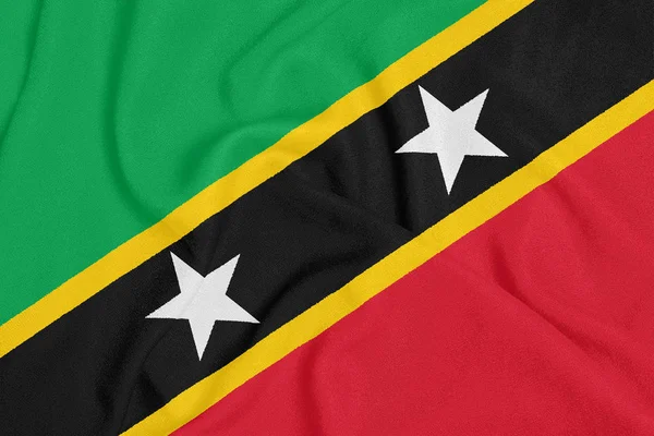 Flaga Saint Kitts i Nevis na teksturowanej tkaniny. Symbol patriotyczny — Zdjęcie stockowe