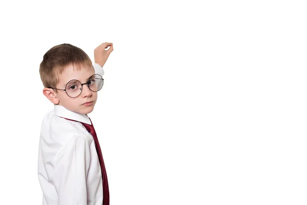 Portrait of a schoolboy in round glasses. Pretends to write on the chalkboard. Isolate — Stock Photo, Image