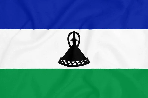 Flaga Lesotho na teksturowanej tkaniny. Symbol patriotyczny — Zdjęcie stockowe