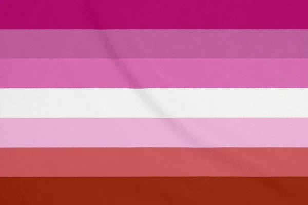ΛΟΑΤ λεσβιακό κοινότητα σημαία σε ένα ύφασμα υφή. Σύμβολο υπερηφάνειας — Φωτογραφία Αρχείου