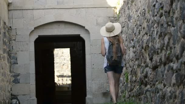 Young Woman Hat Backpack Walks Ancient Walls Touches Her Hand — Stock Video