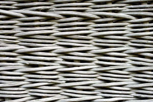 Gray wicker wooden fence. Close-up, front view