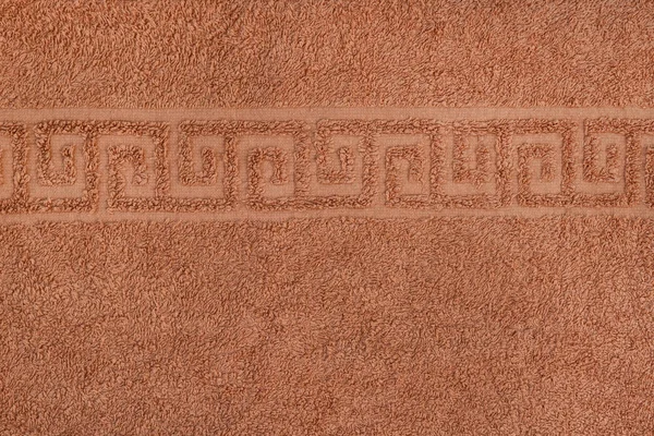 Suave textura sin costuras de una toalla de rizo con adorno griego. Color de arena — Foto de Stock
