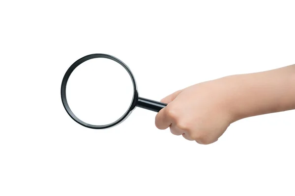 Magnifier in a children's hand on a white background. Close-up — Stock Photo, Image