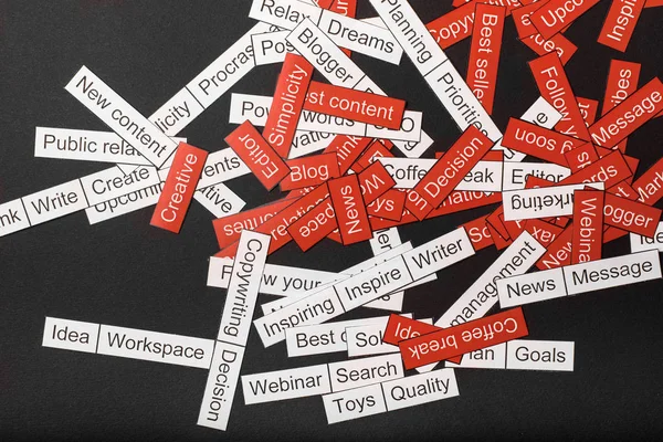 Word cloud of business themes cut out of red and white paper on a gray background — Stock Photo, Image