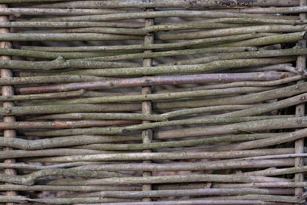 Woven wood fence in village or country house. Rustic style.