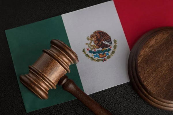 Judge or auction gavel on flag of Mexico. Mexican legislation. Violation of human rights in Mexico.