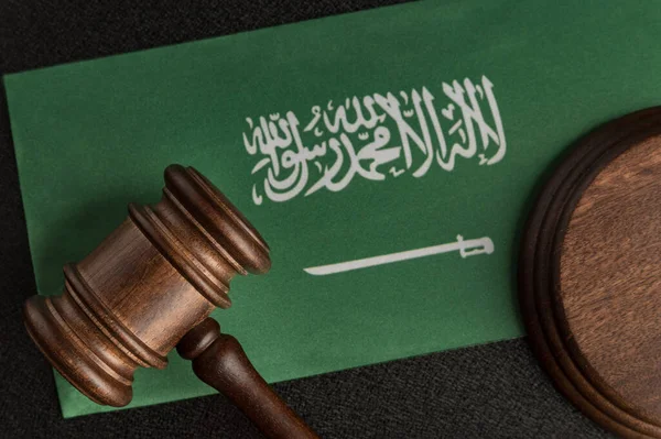 Wooden mallet justice on Saudi Arabia flag. Law library. Law and justice concept