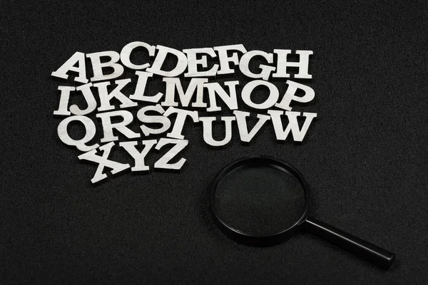 Latin Letters Alphabetical Order Black Background Magnifying Glass — Stock Photo, Image
