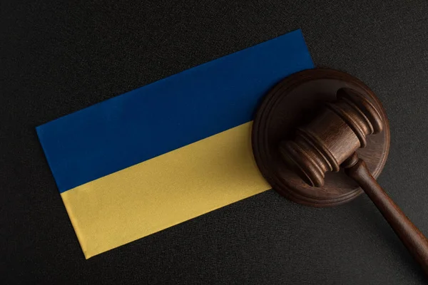 Judge Gavel and flag of Ukraine. Law and justice in Ukraine. Violation of rights and freedoms.