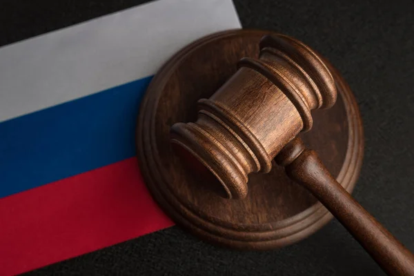 Judge Gavel and flag of Russian Federation. Law and justice in Russia. Violation of rights and freedoms.