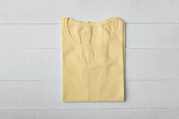 Yellow blank t-shirt on white background. Knitted t-shirt unisex. Mockup.