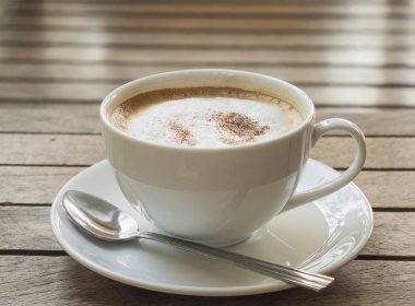 Kahverengi tahta ahşap masa üzerinde kahve fincanı