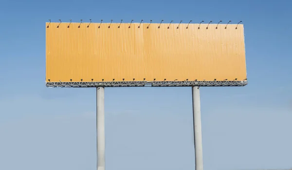 Empty yellow highway billboard over blue sky background, your text here