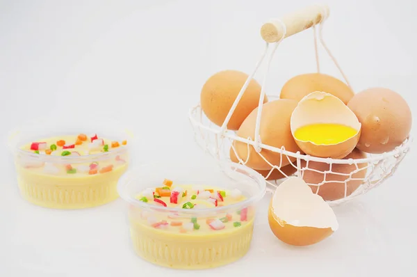 Thai steamed eggs with fresh beaten egg in basket