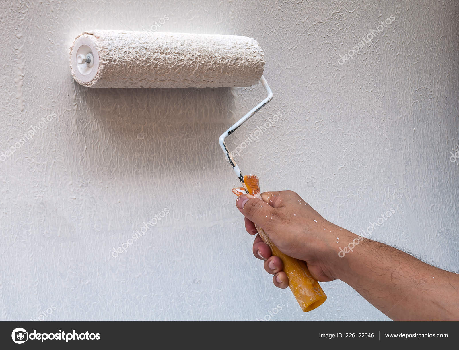 Hand Holding Rolling Paint Brush Wall Painting Stock Photo by