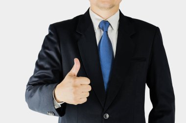 Businessman is doing thumps up sign over white background. Photo is focused at hand. Photo includes clipping path. clipart