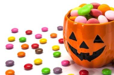 Halloween candies with orange jack o lantern face - halloween background concept clipart