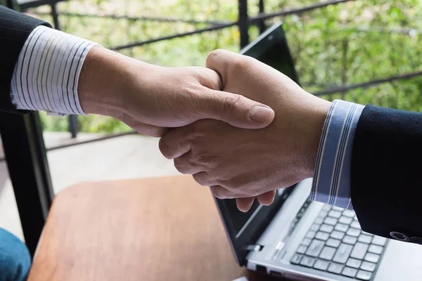 Business people join hand together during their meeting - commitment teamwork concept