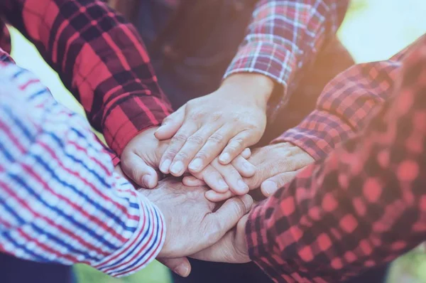 People group join hands together as teamwork unity symbol during their meeting activity to achieve their ultimate goal.