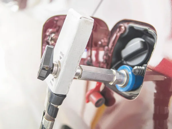 NGV, Natural Gas Vehicle, head dispenser with a car at the gasoline station in Thailand