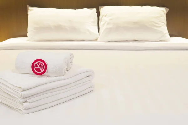 White bedding and towel set in modern hotel
