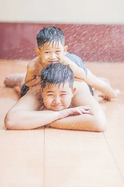 暑い季節の間に噴霧水で子供たちが喜んで遊んでいます — ストック写真