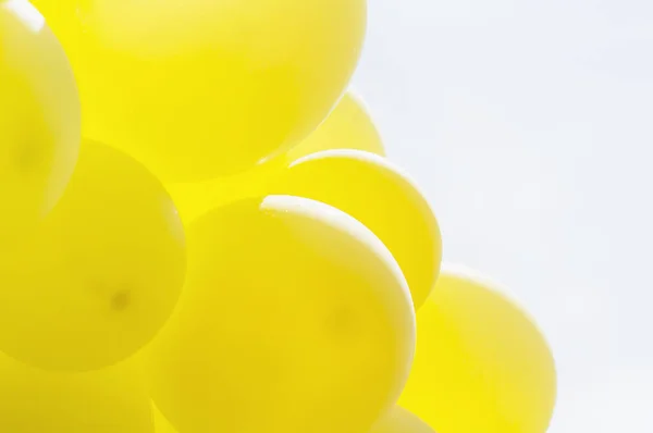 Yellow balloon with blue bright sky background