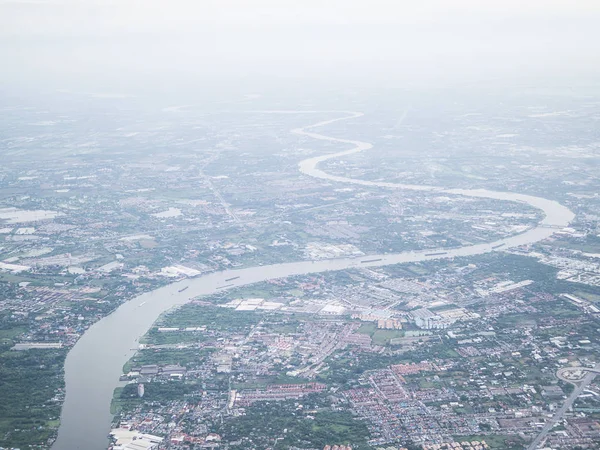 Soft focused of aerial view of Bangkok city and Chao Phraya river with morning fog overlay, capital of Thailand