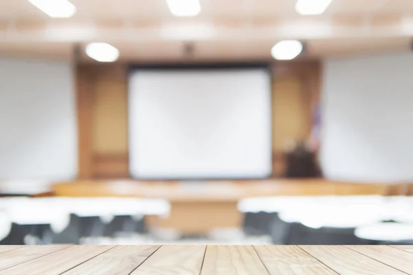 Wooden plank floor over blurred of empty lecture room