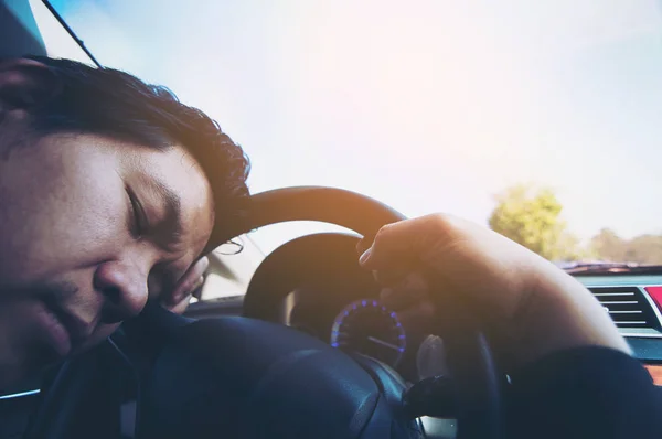 Man sleep in car while driving on the road - people tried from long drive and traffic concept