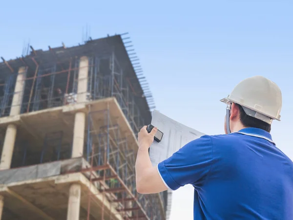 Engineer is inspecting his work in building construction site