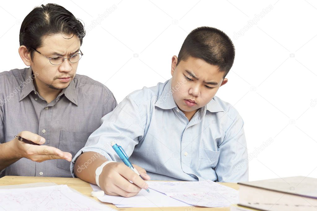 Asian father teaching homework to his 14 years son seriously
