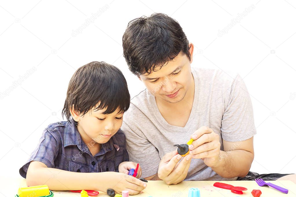 Father is playing Halloween clay with his son over white background