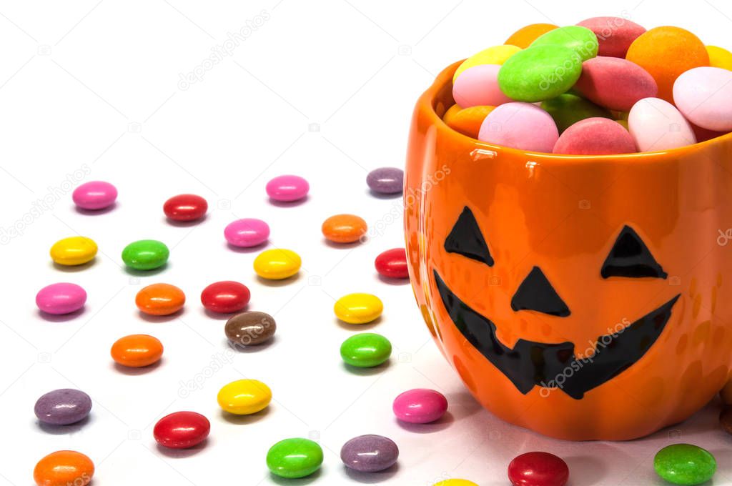 Halloween candies with orange jack o lantern face - halloween background concept