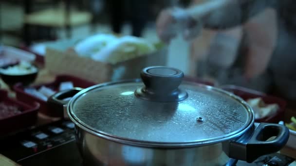 Closeup Lady Hand Opening Steam Sukiyaki Pot Lid — Stock Video