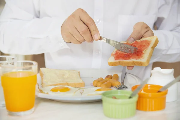 Business man eat the American breakfast set in a hotel - people take a breakfast in hotel concept