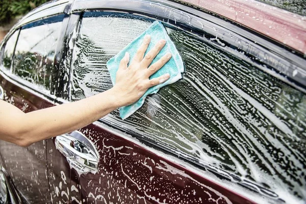 Man wash car using shampoo - every day life car care concept
