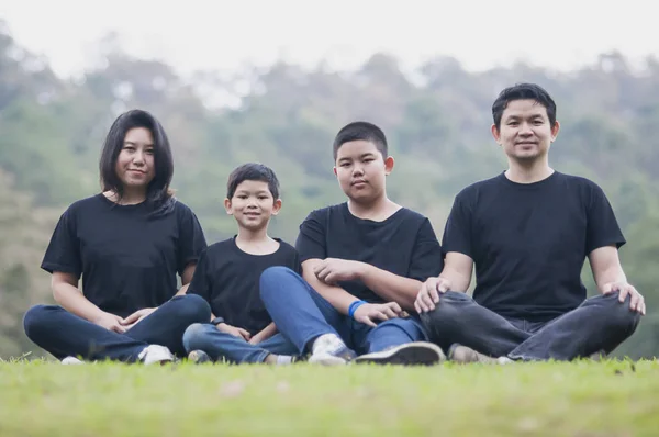 Asian dad mom with two son in nature - happy Asian family concept