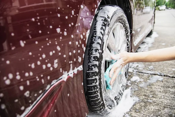 Man wash car using shampoo - every day life car care concept